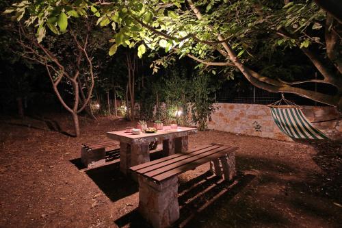 a picnic table in a park at night at Koromilia Villa in Neo Klima