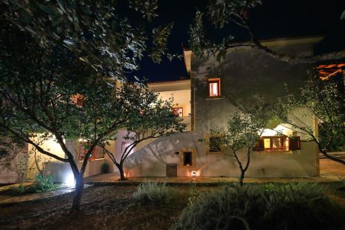 a house at night with lights on the side of it at Koromilia Villa in Neo Klima