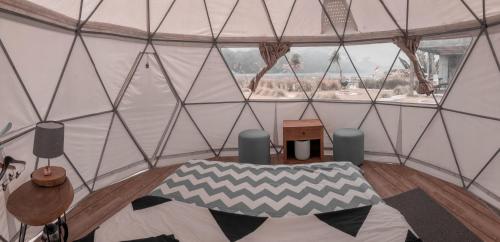 a room with a tent with a bed in it at Igloo Glamping Bali in Kintamani