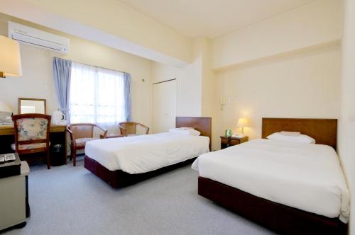 Llit o llits en una habitació de Sky Heart Hotel Kawasaki