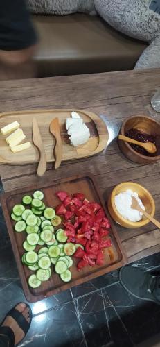 a table with cheese and vegetables on a cutting board at HOTEL N1 in Yerevan