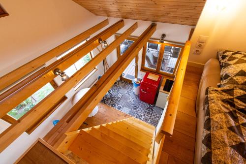 an overhead view of a room with a staircase in a tiny house at Napkelet Vendégház in Nagymaros