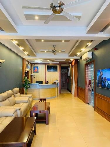 a living room with a couch and a tv at LEYSHOF HOTEL in Mwanza