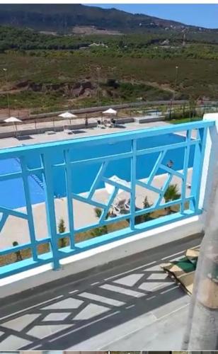 a blue railing on top of a building with a view at Oceanica by Smir Park luxury apartment Marina Smir in M'diq