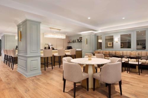 a dining room with a table and chairs at Hotel Avenue Louise Brussels Trademark Collection by Wyndham in Brussels