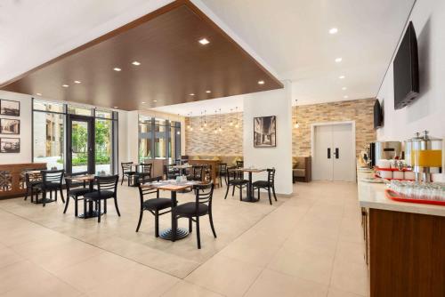 a kitchen and dining room with tables and chairs at Super 8 by Wyndham Dubai Deira in Dubai