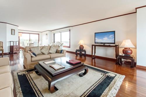 a living room with a couch and a table at Saigon Domaine Luxury Residences in Ho Chi Minh City