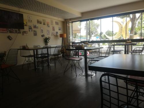 a restaurant with tables and chairs and a large window at Rumeli Konak Butik Otel in Tekirdag