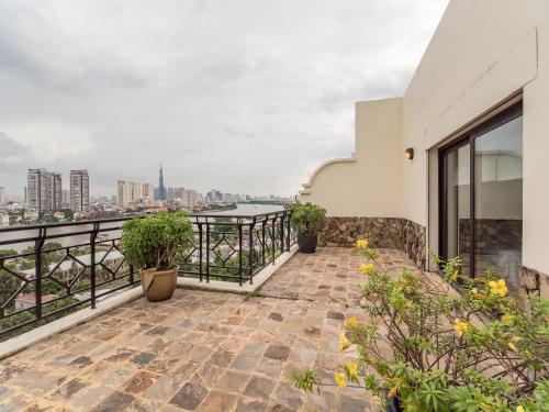 a balcony with potted plants and a view of the city at Saigon Domaine Luxury Residences in Ho Chi Minh City