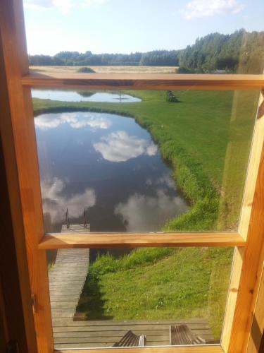 a view of a river from a window at Aratsaare Holiday home in Kõpu