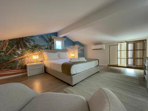 a bedroom with a bed with a painting on the wall at Merim Apartments in Ponte de Lima