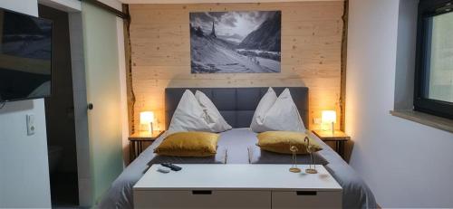 a bedroom with a bed with two pillows on it at Haus Fien in Heiligenblut
