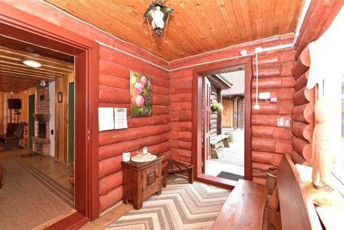 a room with a wooden wall with a door and a window at Sodyba Sauletekis in Ignalina