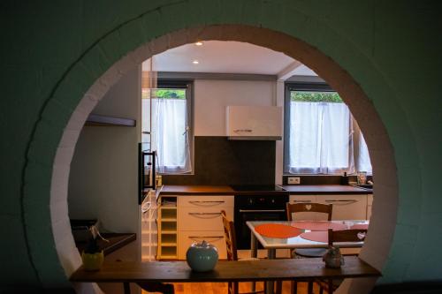 a kitchen with an archway over a table in a kitchen at Le Chalet de Gaume in Virton