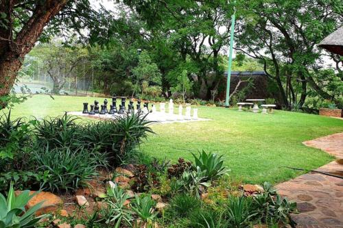 a park with a chess board in the grass at Rustic River & Bush Escape in Buffelspoort