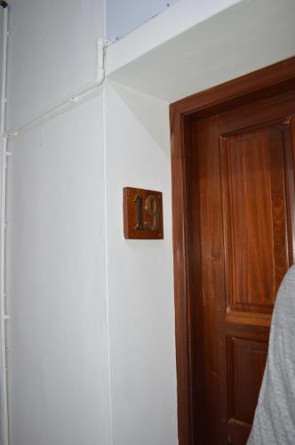 a wooden clock on a wall next to a door at Maurer Loisirs Ltee in Trou aux Biches