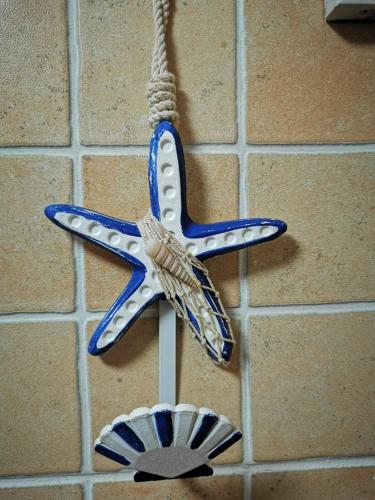 a blue and white star ornament hanging on a wall at Cosy duplex in Agaete with WIFI in Agaete