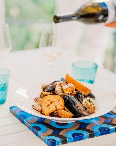 a plate of mussels and other food on a table at San Montano Resort & Spa in Ischia