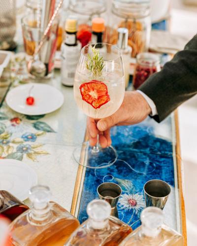 a person holding a wine glass with a flower on it at San Montano Resort & Spa in Ischia