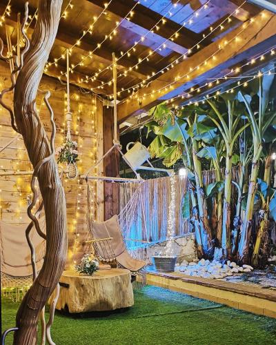 a room with a hammock and trees and lights at Favola B&B in Pescara