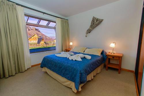Una cama o camas en una habitación de Melewe Apart hotel Caviahue