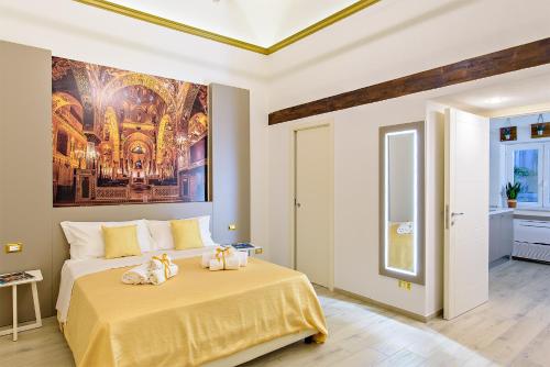 a bedroom with a bed with a painting on the wall at Barlaman Luxury Rooms in Palermo