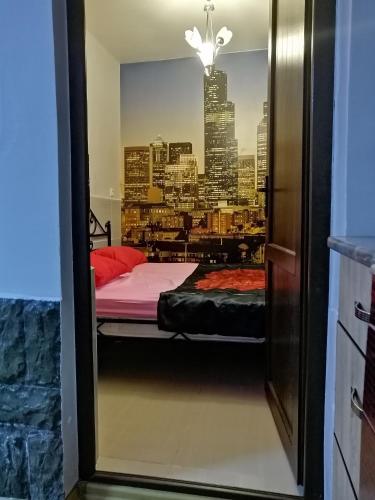 a bedroom with a bed and a view of a city at Apartment "Ceazars" in K'obulet'i