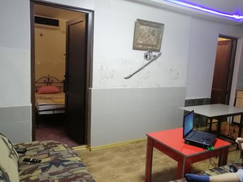 a living room with a laptop on a red table at Apartment "Ceazars" in K'obulet'i