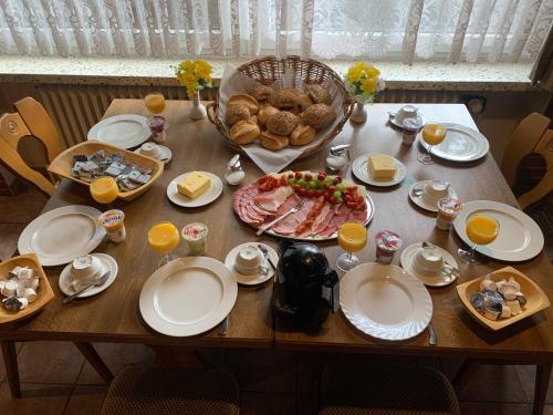 a wooden table with plates and food on it at Zur Krone in Seelze