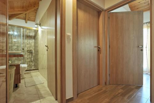 加拉希德松的住宿－Giannitsa's House，浴室设有木制四柱门和卫生间。