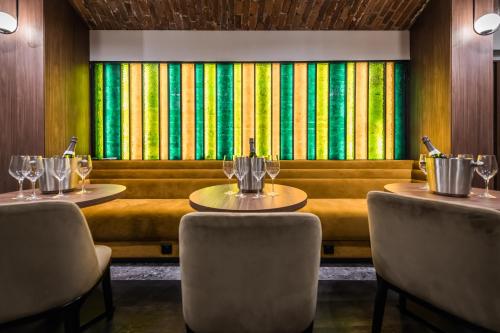 a restaurant with two tables and chairs and a couch at Liebeskind Boutique Hotel Old Town in Kraków