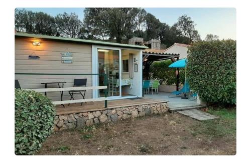a tiny house with a porch and a patio at Orasi Sartène Chalet Casa Fiurita in Sartène