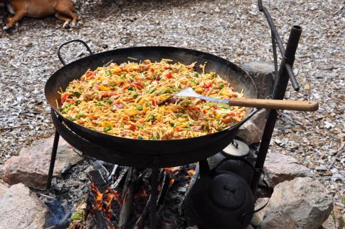 a pan of food cooking on top of a fire at Kröken in Kvillsfors