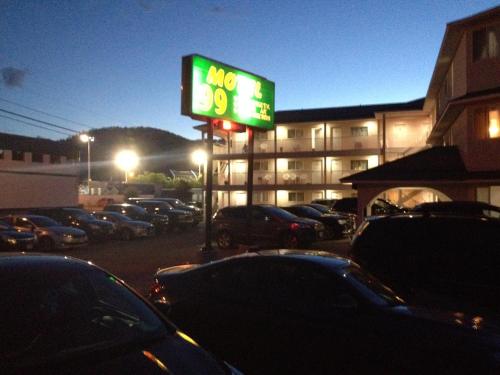 a parking lot with a mgm sign in front of a hotel at Motel 99 in Grand Forks