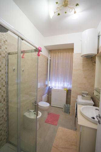 a bathroom with a shower and a toilet and a sink at Apartment Lemon in Catanzaro