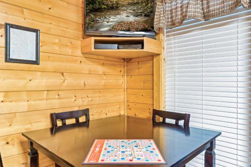 a dining room with a table and two chairs at Cozy log cabin!! In heart of PF & close to the Smokies in Pigeon Forge