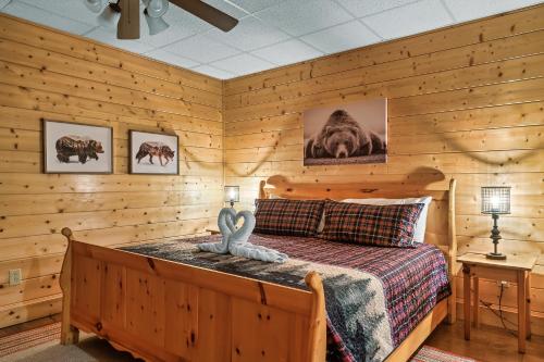 a bedroom with a bed in a log cabin at Cozy log cabin!! In heart of PF & close to the Smokies in Pigeon Forge