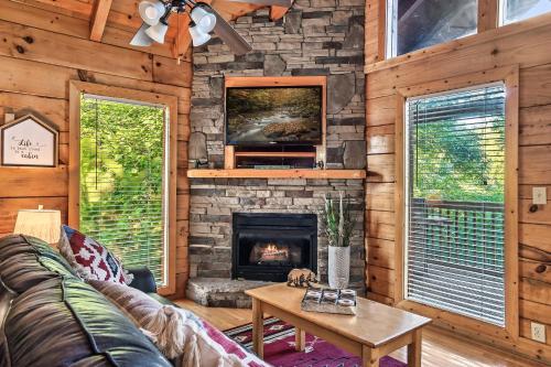 a living room with a couch and a fireplace at Cozy log cabin!! In heart of PF & close to the Smokies in Pigeon Forge