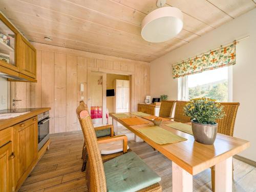 a kitchen and dining room with a wooden table at Apartment with barbecue in M hrenbach in Möhrenbach