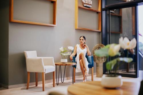 a woman sitting in a chair in a room at AM Palace in Ulcinj