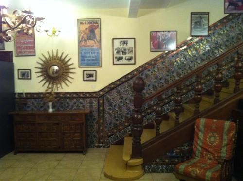 a staircase in a house with pictures on the wall at Hostal Paracuellos in Paracuellos de Jarama