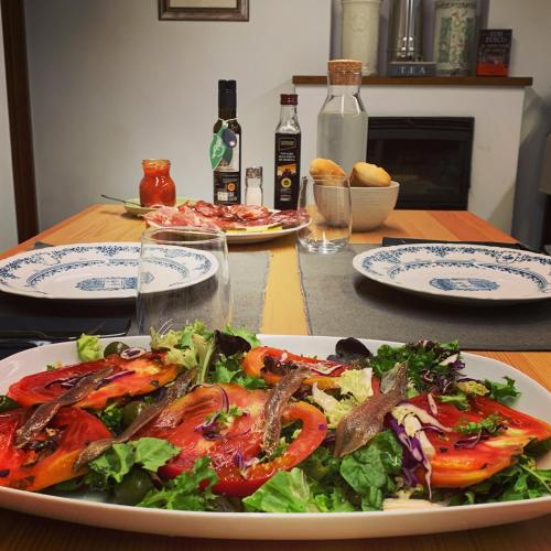 a table with two plates of food and a salad at Castillo de Bulbuente de Luis Zueco in Bulbuente
