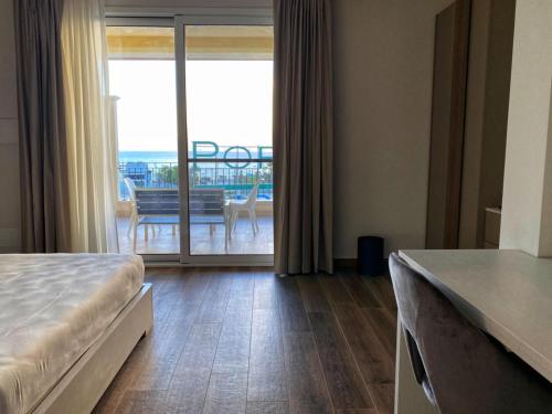 a bedroom with a bed and a view of a balcony at Lumarooms B&B in Reggio Calabria