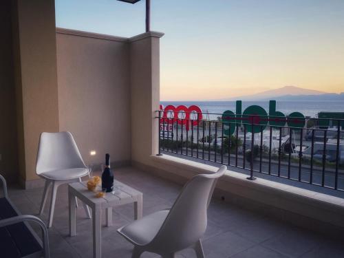 a balcony with chairs and a view of the ocean at Lumarooms B&B in Reggio Calabria