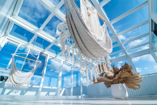 a room with hammocks hanging from the ceiling at W3 HOSTEL in Luodong