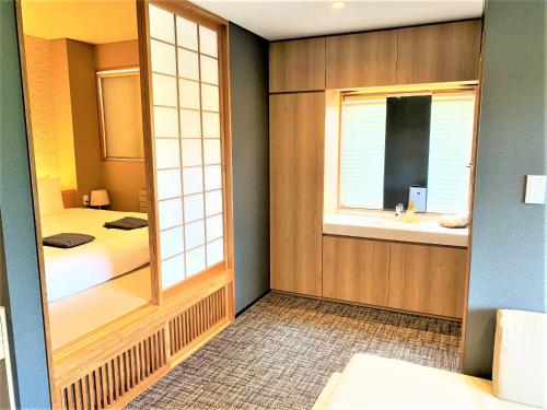 a room with a mirror and a bed and a window at Miru Niseko in Kutchan