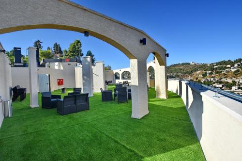 an outdoor patio with green grass and an archway at Romano Hotel Boutique in Safed