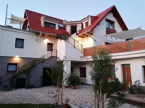 a view of a building with red roof at Szigligeti Mandula Kert Vendégház in Szigliget