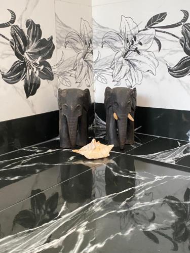 a couple of elephants standing on a table at Sapphire Garden Hotel in Habarana