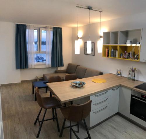 a kitchen and living room with a table and a couch at Pula Center Seaview Apartment in Pula